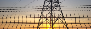 Transmission line at sunset with fence_Canva.png
