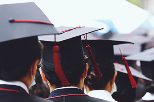 Group of Graduates during commencement stand in row. Concept education congratulation in University. Graduation Ceremony. copy space banner_AdobeStock_386347095.jpeg