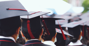 Group of Graduates during commencement stand in row. Concept education congratulation in University. Graduation Ceremony. copy space banner_AdobeStock_386347095.jpeg